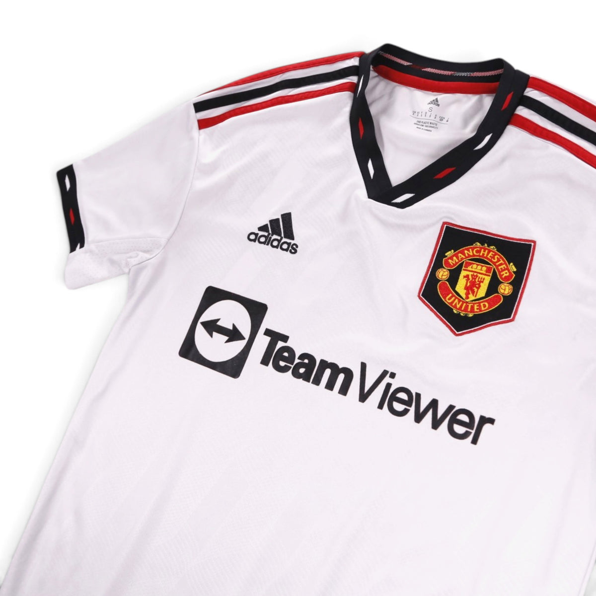 Close-up of adidas logo, Manchester United crest, TeamViewer sponsor and V-neck collar