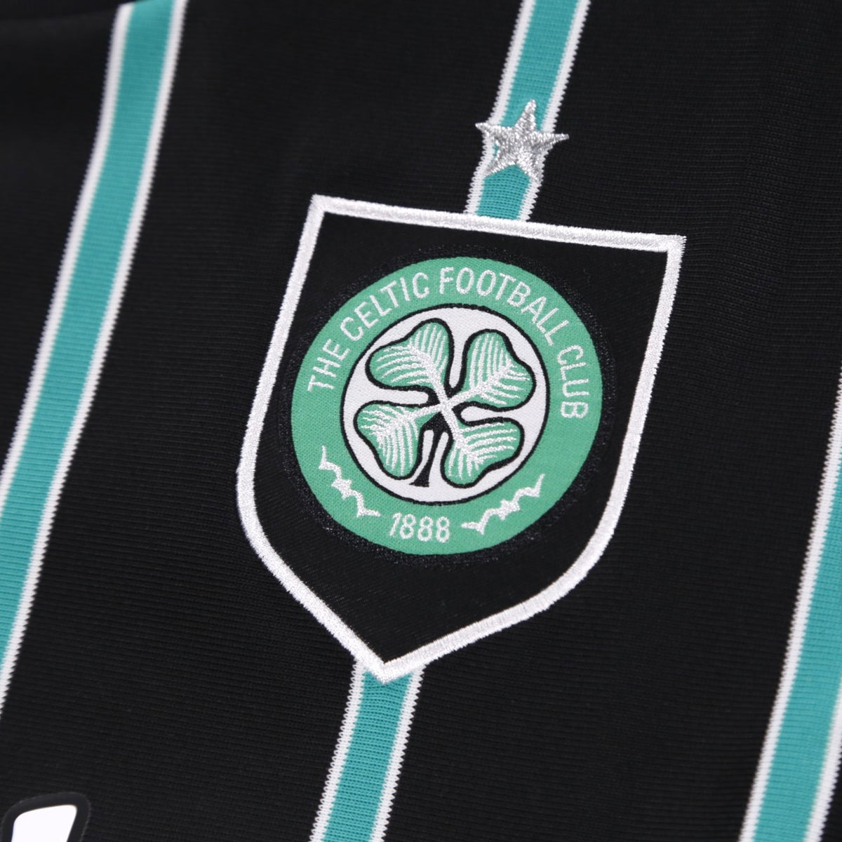 Close-up detail of the Celtic crest with embroidered star above the shield