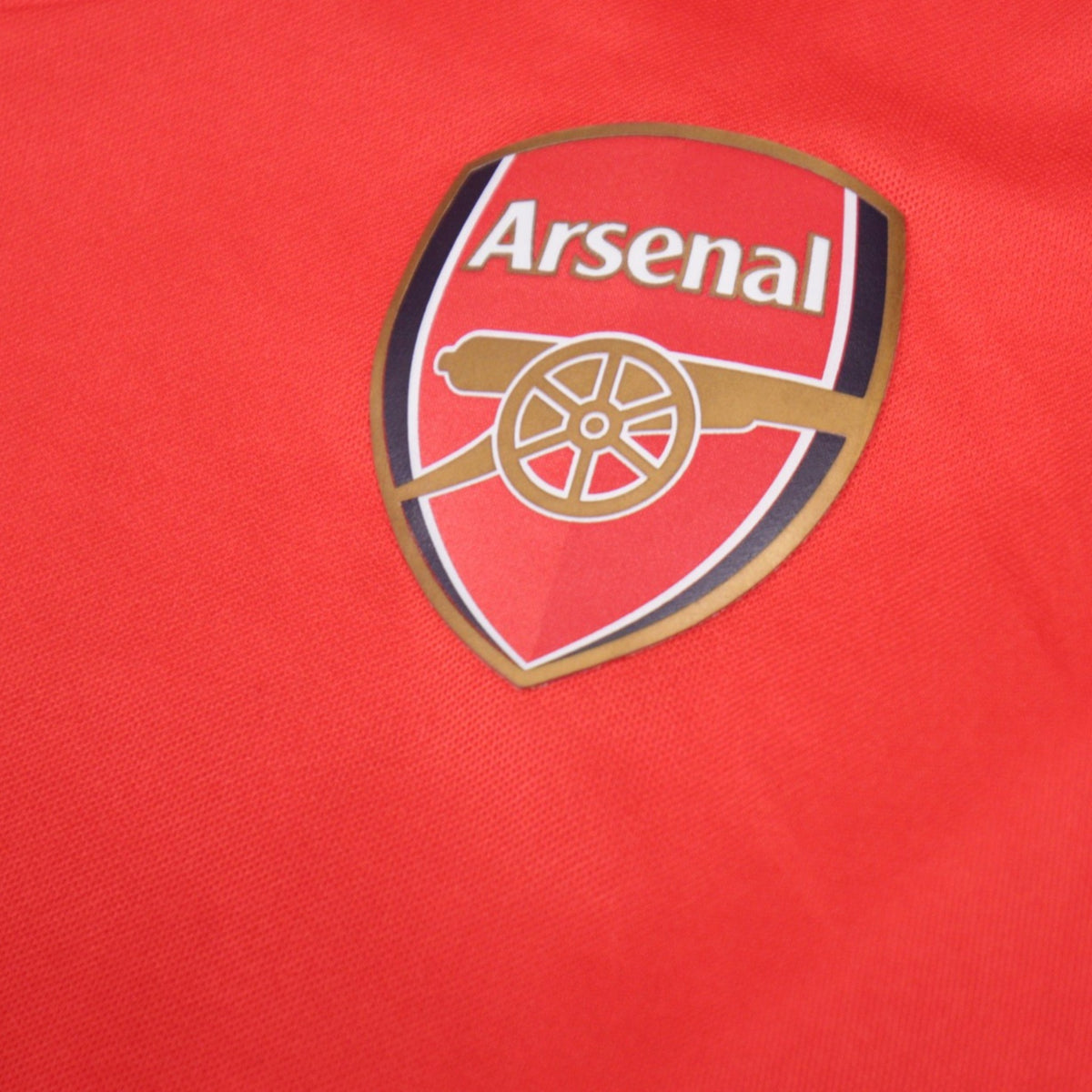 Close-up of the Arsenal crest on the shirt