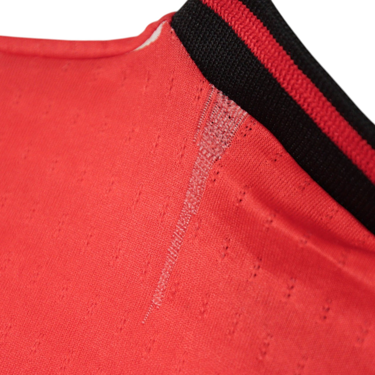 Close-up of shoulder seam showing a faint mark on the fabric