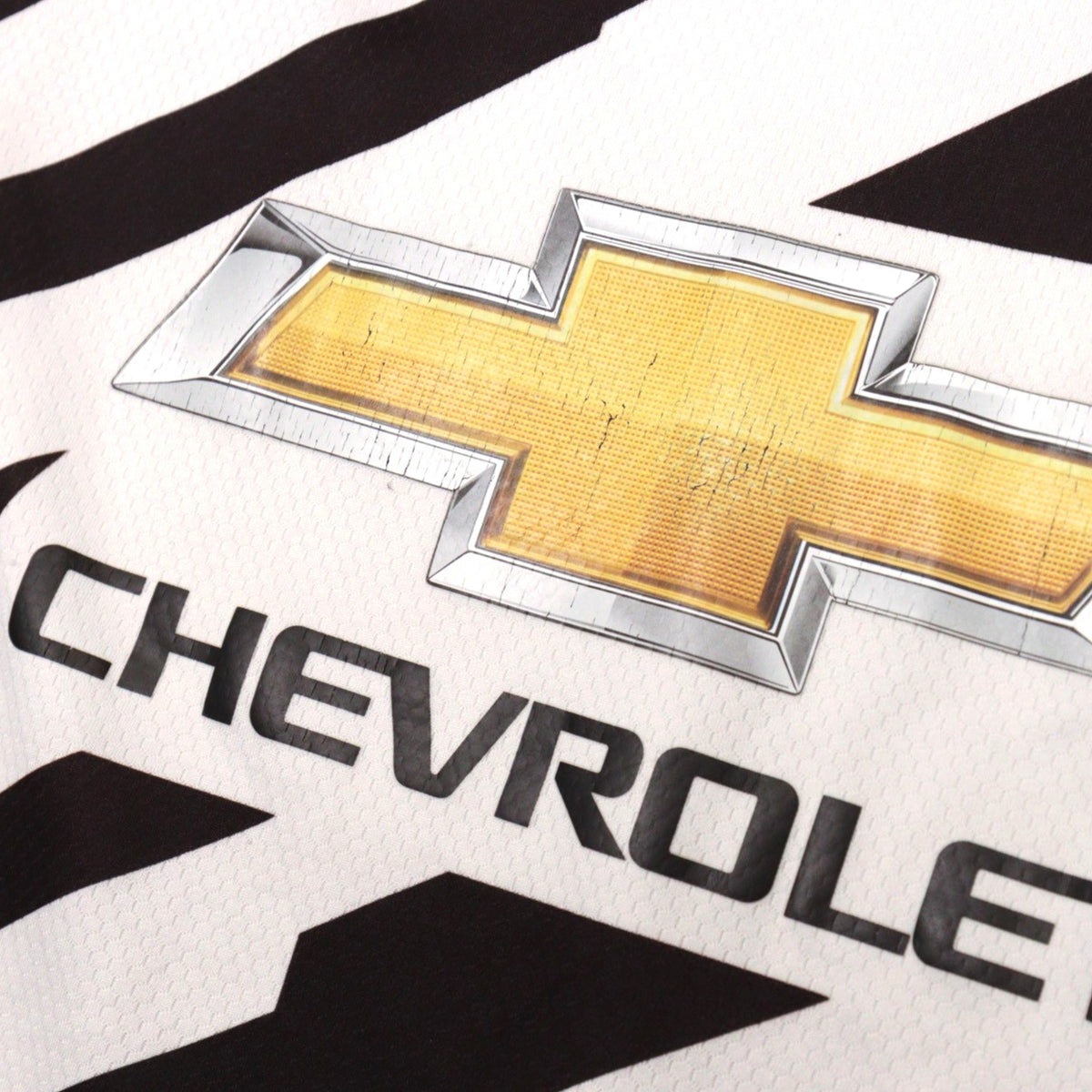 Close-up of the Chevrolet logo print on the Manchester United shirt
