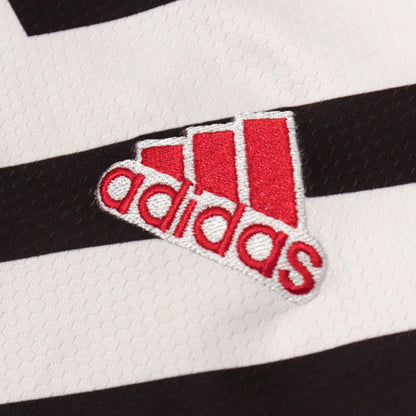 Close-up of the adidas logo on the Manchester United shirt