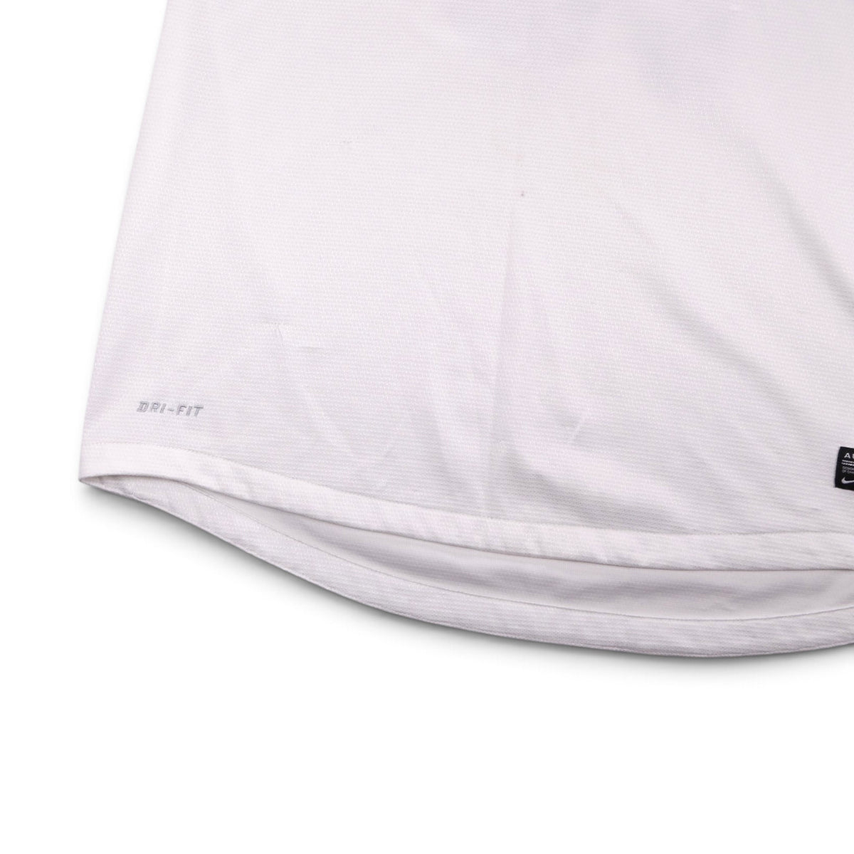 Close-up of shirt hem showing Dri-FIT wordmark and Authentic tag