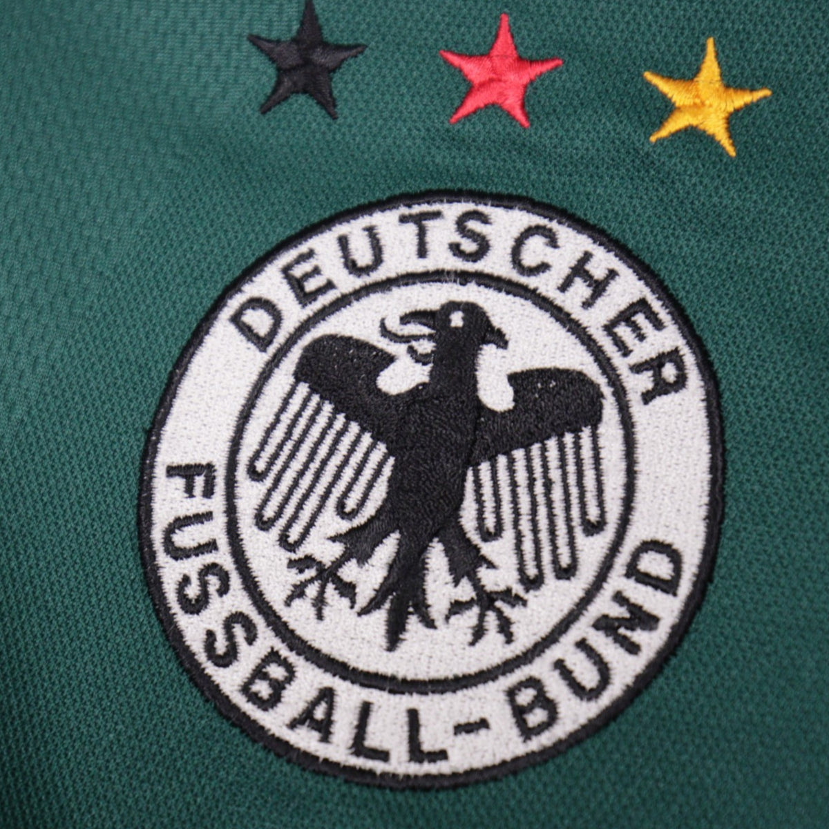 Detail of the three-star DFB eagle crest embroidery on the Germany shirt