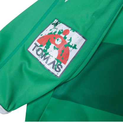 Close-up of a cracked Tomas patch on the sleeve of the shirt