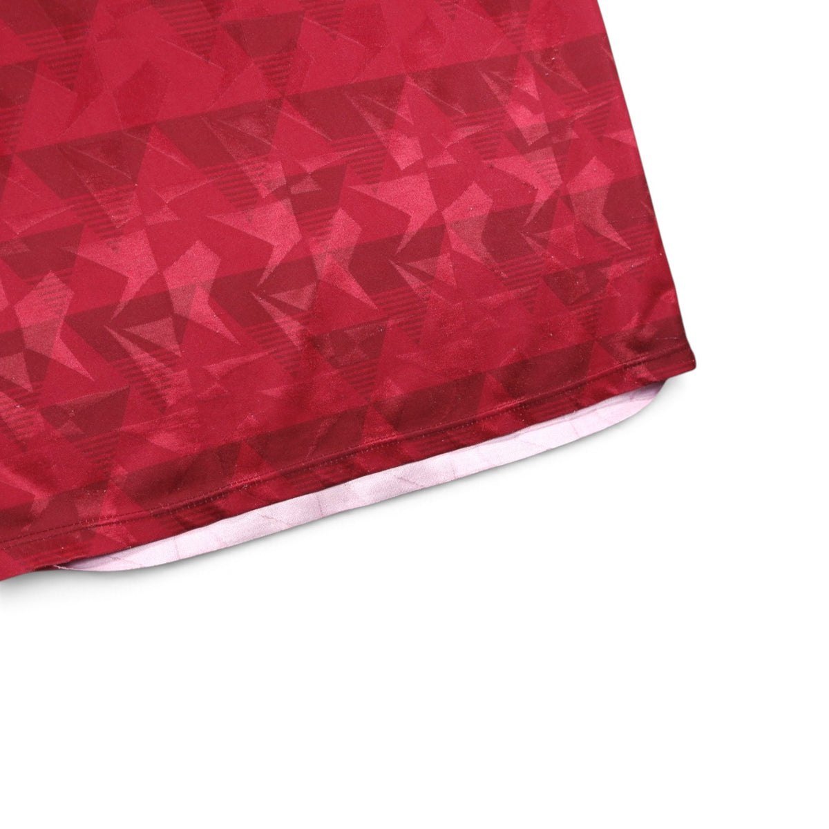 Close-up of the claret geometric jacquard pattern on the hem