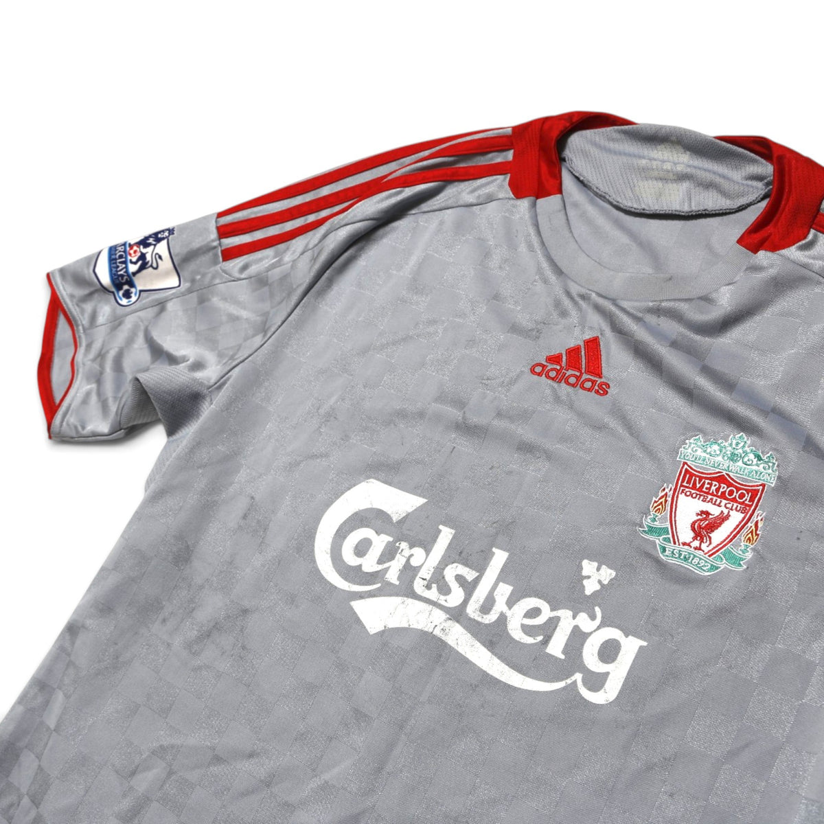 Close-up of Liverpool crest, adidas logo and Carlsberg sponsor on shirt front