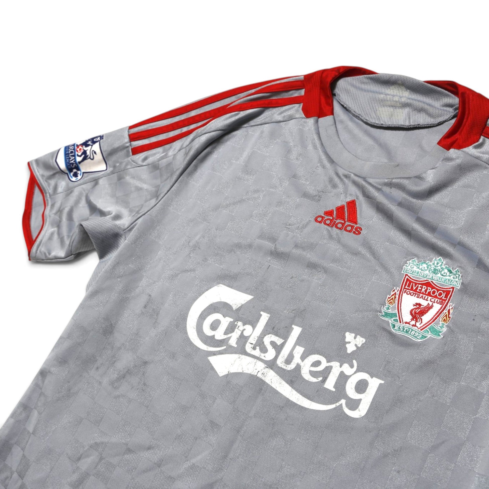 Close-up of Liverpool crest, adidas logo and Carlsberg sponsor on shirt front