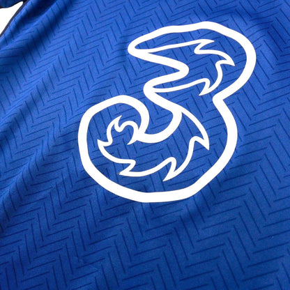 Close-up of the Three sponsor logo printed across the chest of the Chelsea shirt