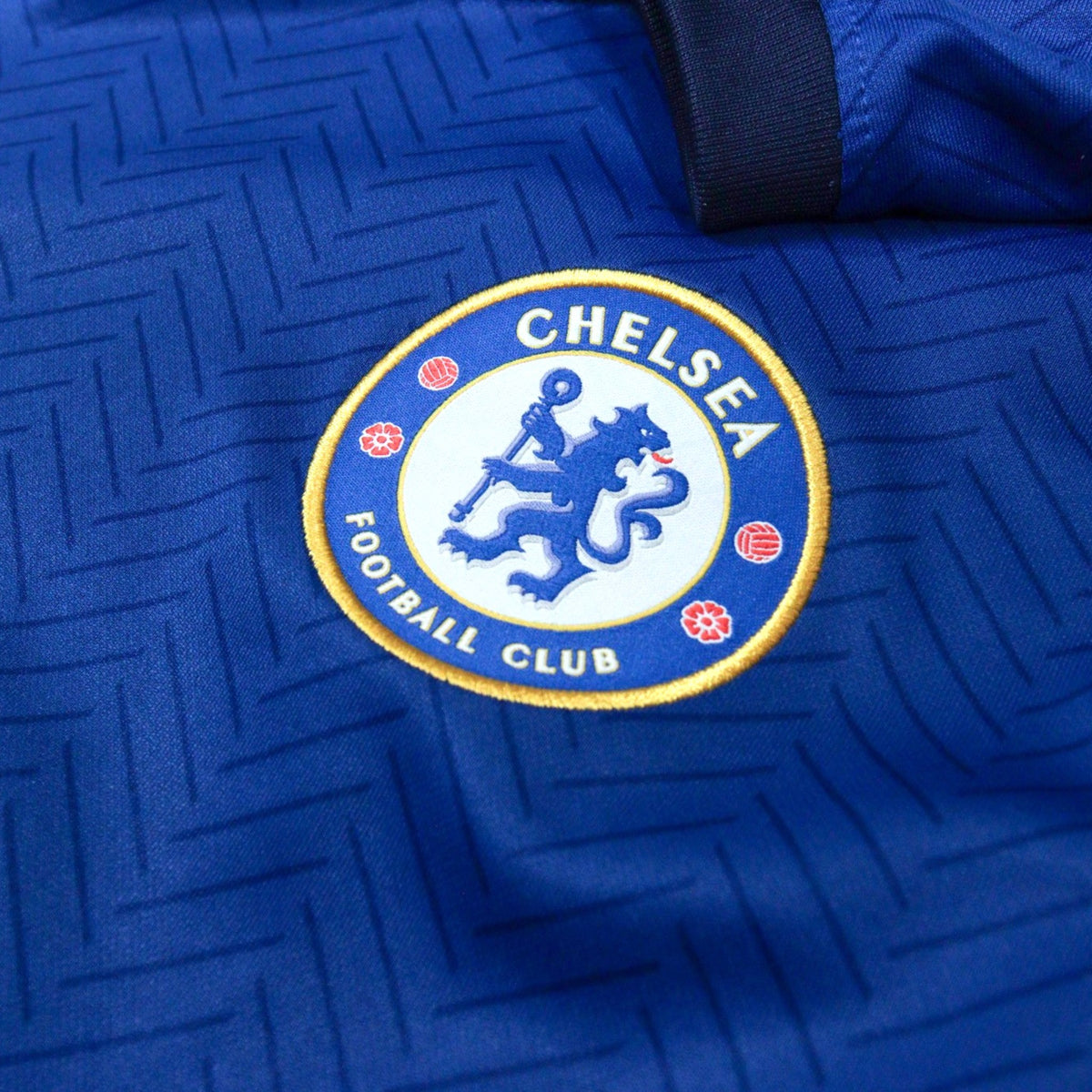 Close-up of the Chelsea crest on the chest of the home shirt