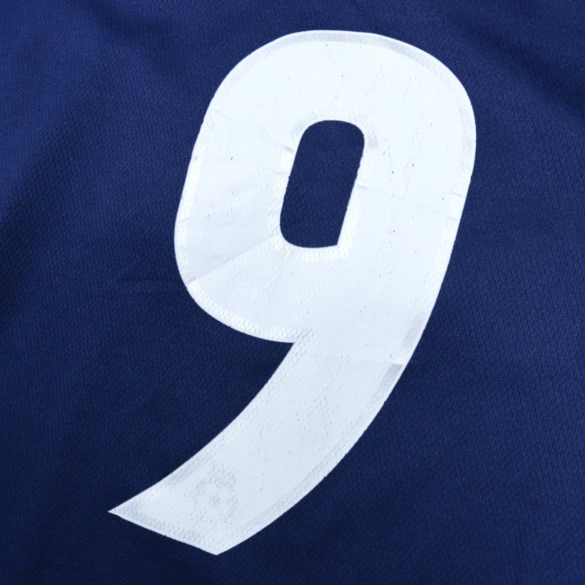 Close-up of the number 9 printed on the back of the shirt