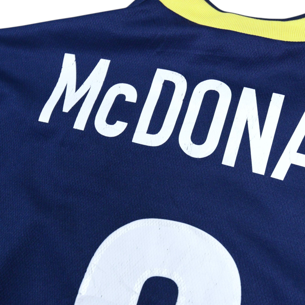 Close-up of the McDonald name and number 9 on the back of the shirt