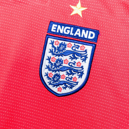Close-up of England crest with gold star above it on the chest