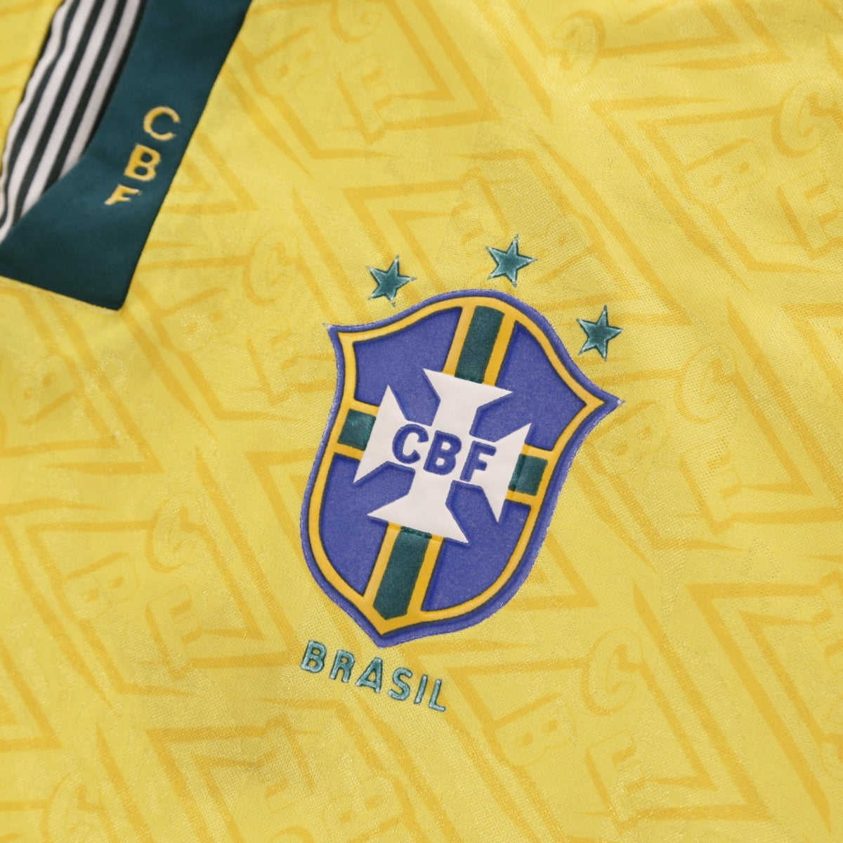 Close-up of CBF crest with three stars on Brazil home shirt