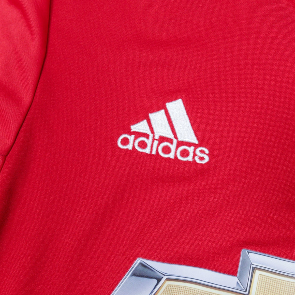 Close-up of the adidas logo on the chest