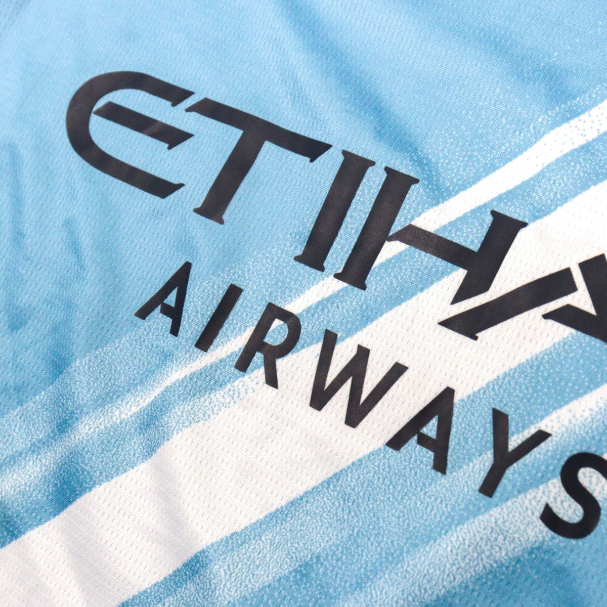 Close-up of the Etihad Airways sponsor print on the chest