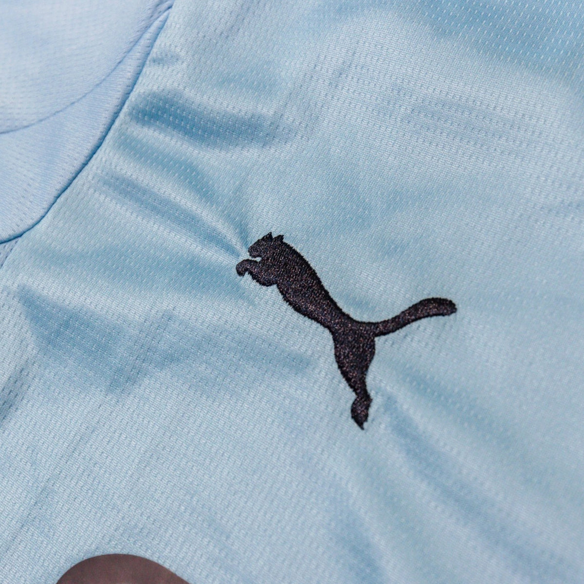 Close-up of the Puma logo embroidered on the chest
