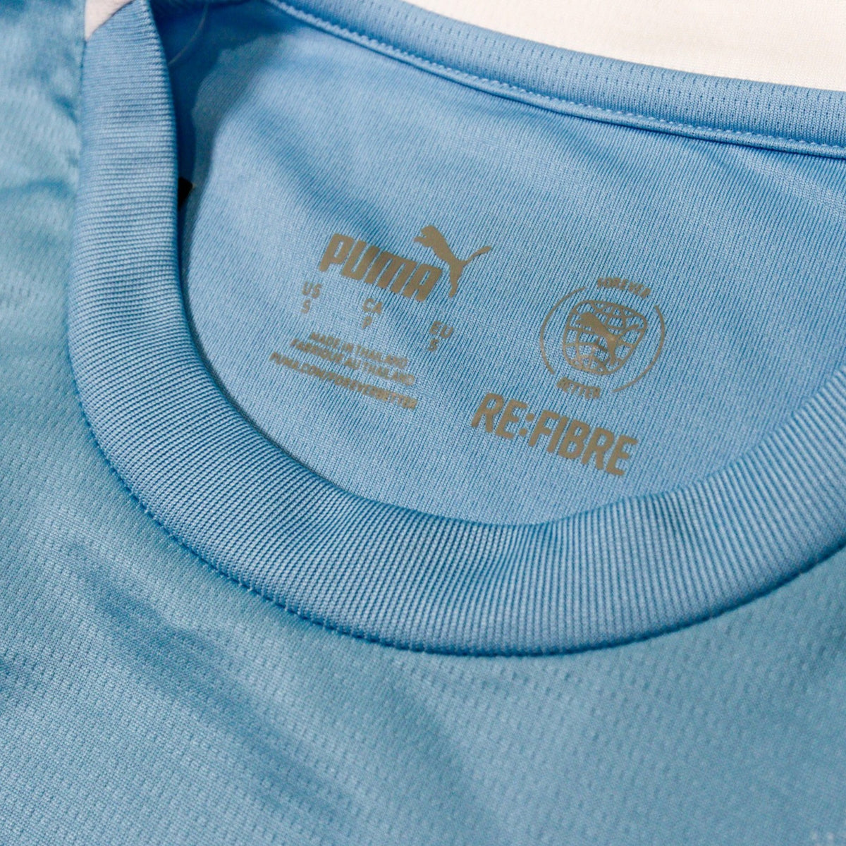 Close-up of the neck label showing Puma branding, size S and Re:Fibre mark