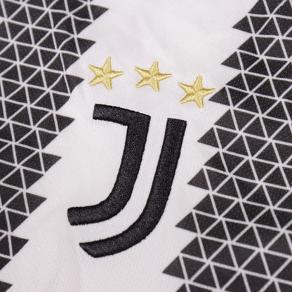 Close-up of the Juventus crest with three gold stars on the shirt