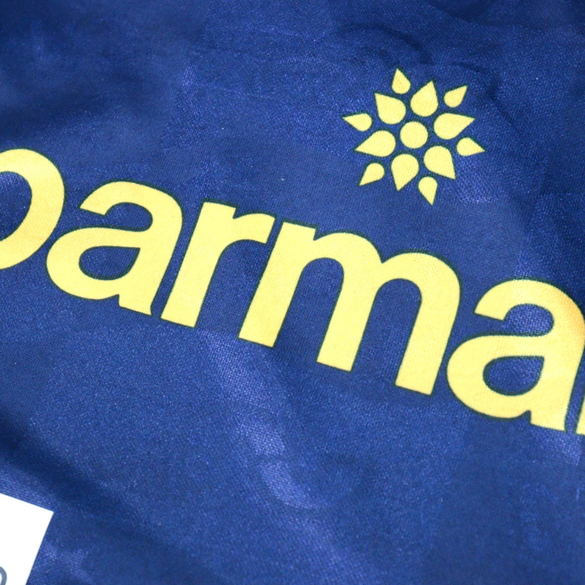 Close-up of Parmalat sponsor print on navy fabric