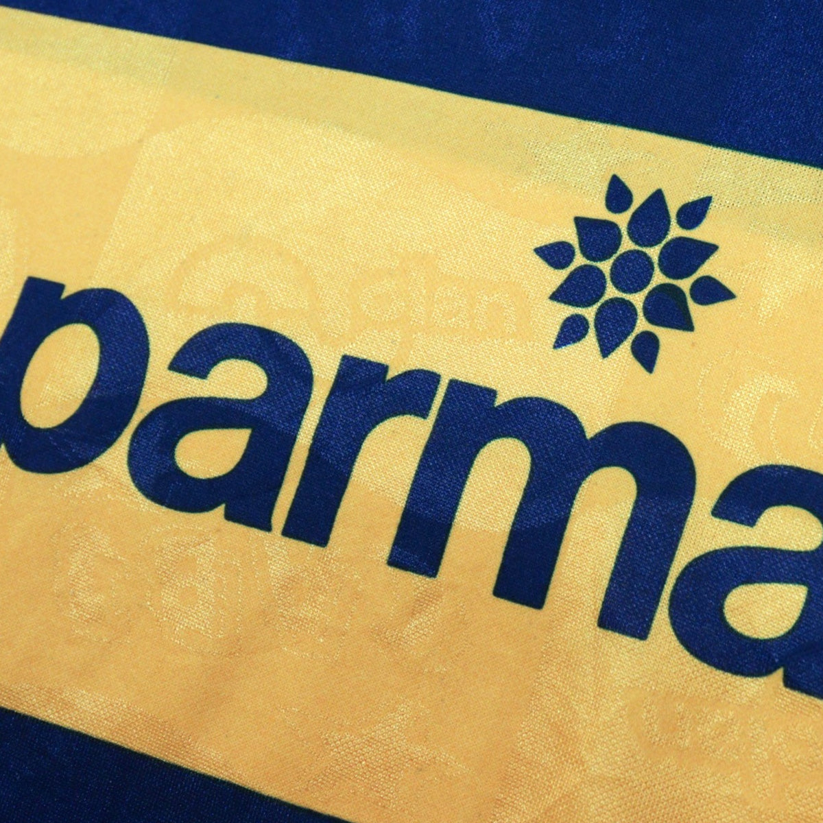 Close-up of Parmalat sponsor print on gold chest band