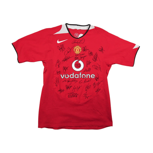 Front of red Manchester United 2004/05 home shirt covered in squad autographs