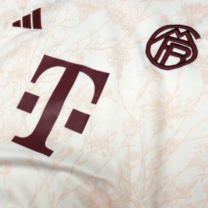 Close-up of Telekom sponsor and Bayern Munich crest on chest