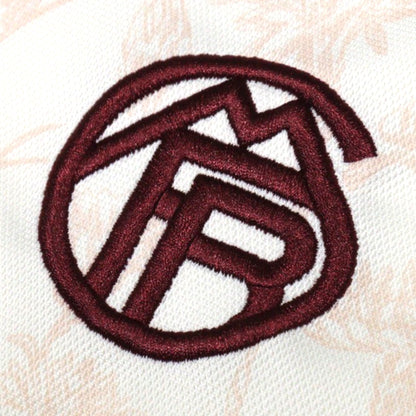 Close-up of embroidered Bayern Munich crest in maroon