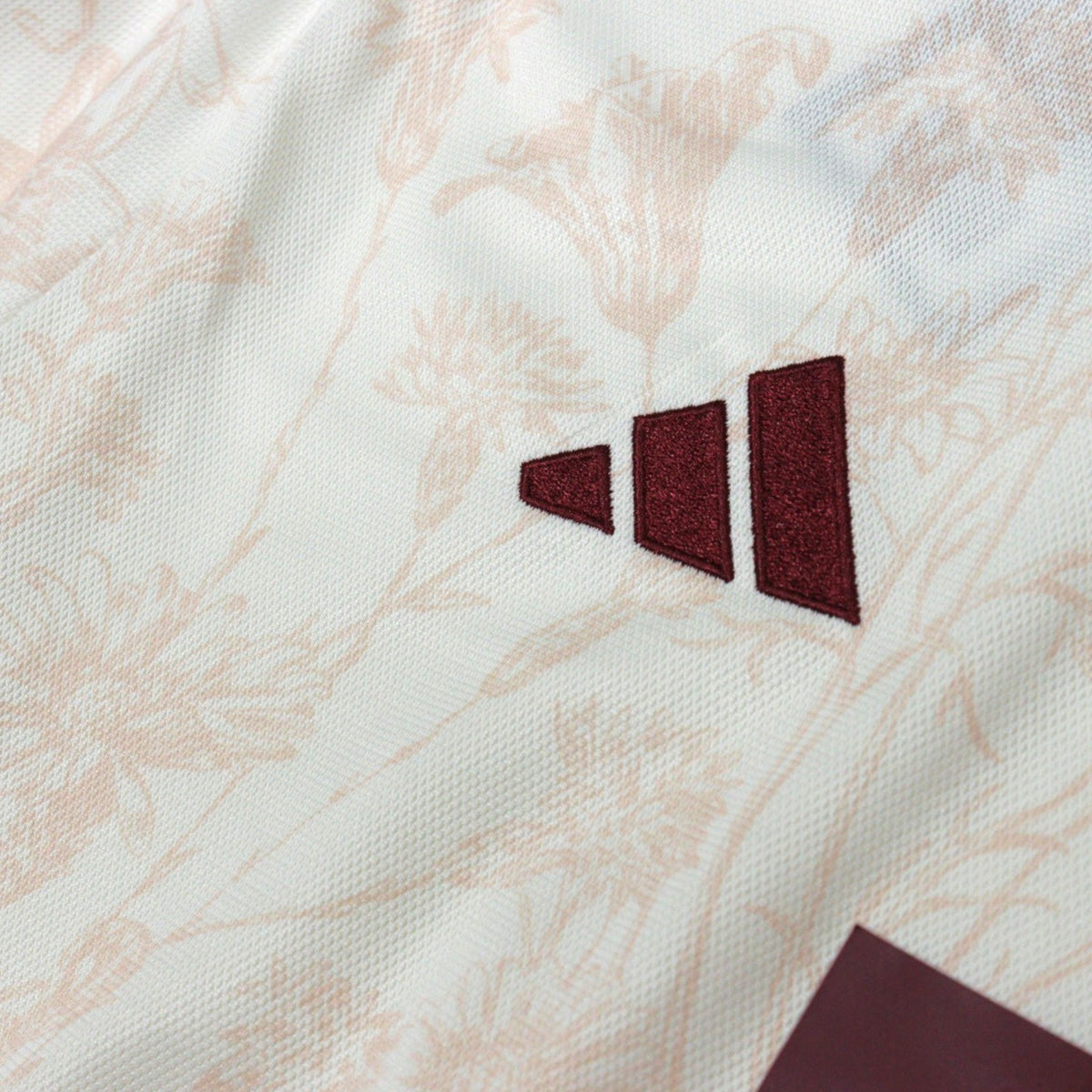 Close-up of adidas logo on the chest