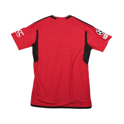 2023/24 Manchester United home shirt, back view showing plain red back and sleeve patches