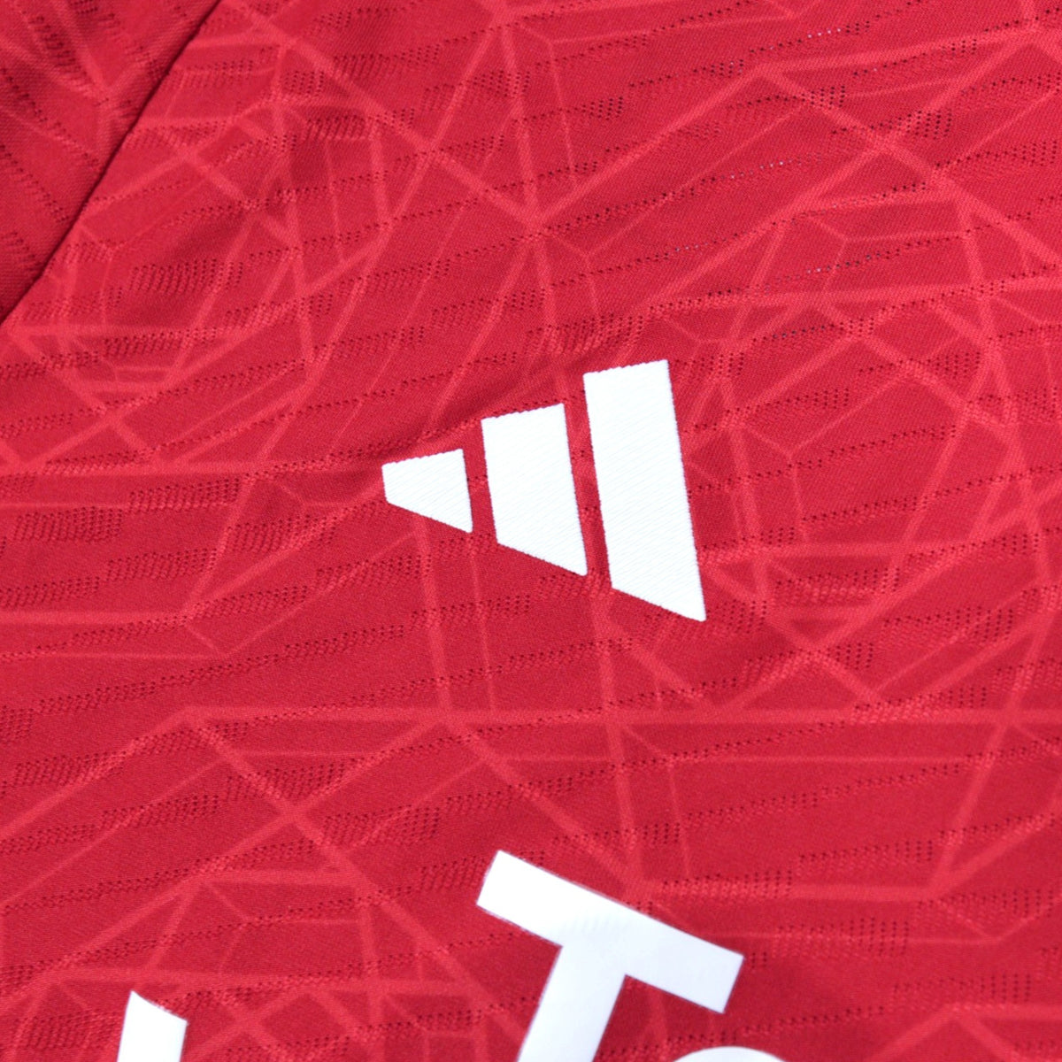 Close-up of the adidas logo on the chest of the 2023/24 home shirt