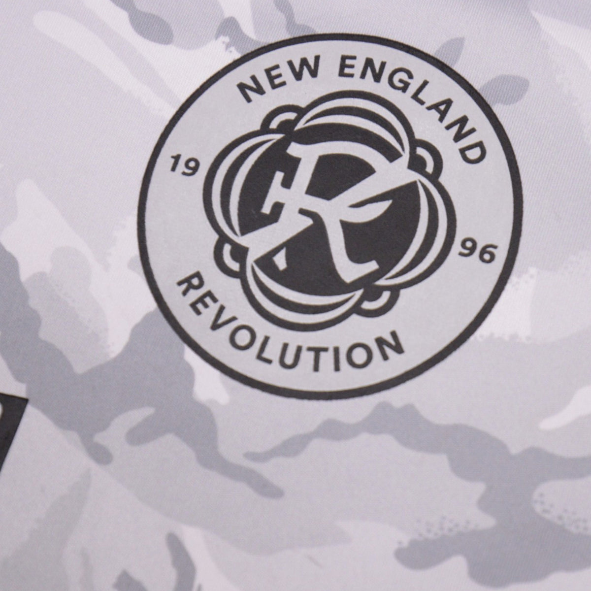 Close-up of the New England Revolution club crest printed on the shirt