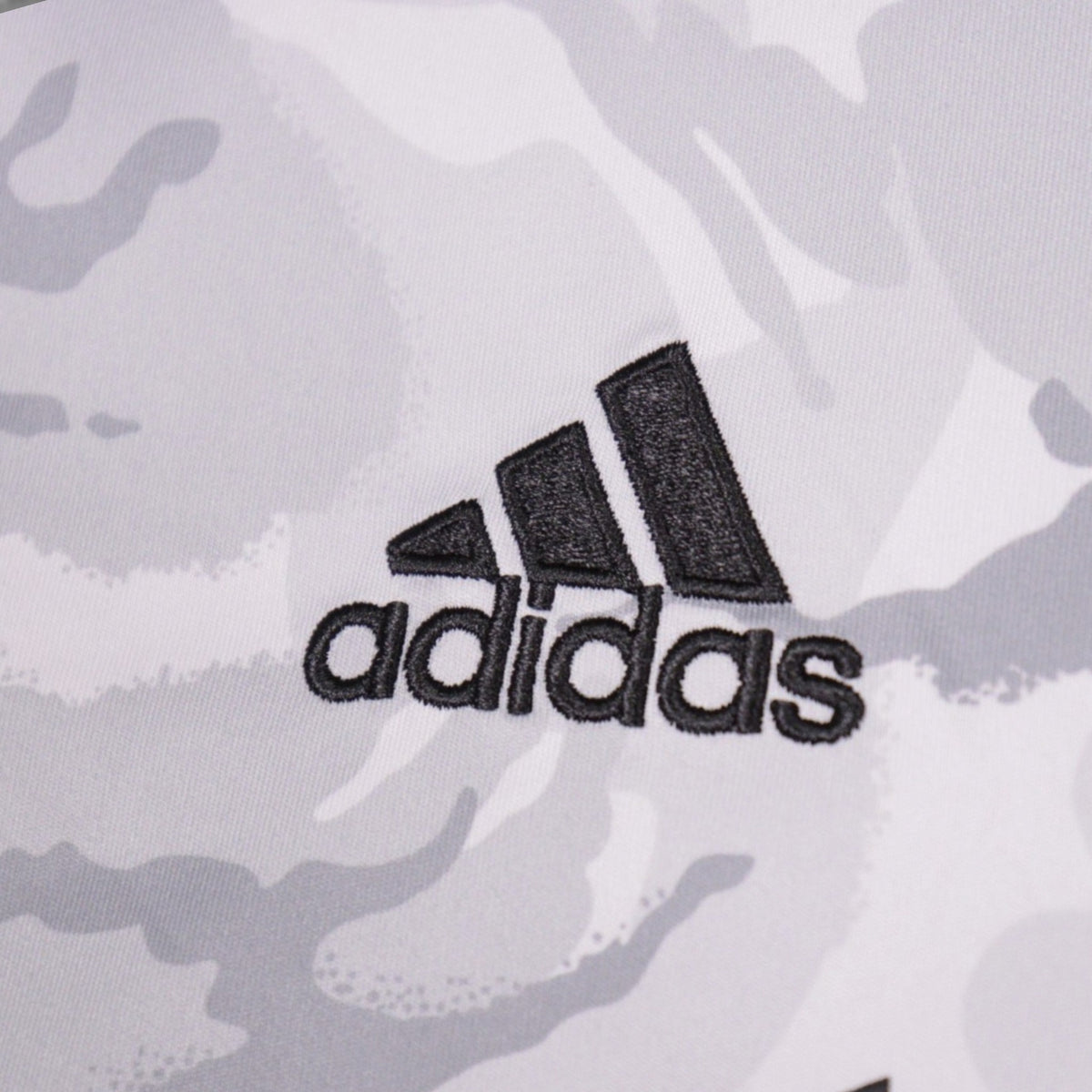 Close-up of the embroidered adidas logo on the New England Revolution away shirt