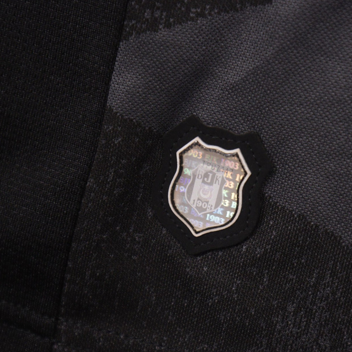 Close-up of the Besiktas club tag sewn onto the shirt hem