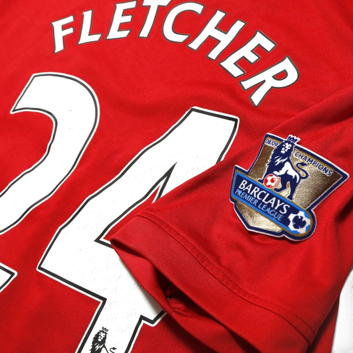 Close-up of Fletcher 24 print and Barclays Premier League 08/09 Champions sleeve patch