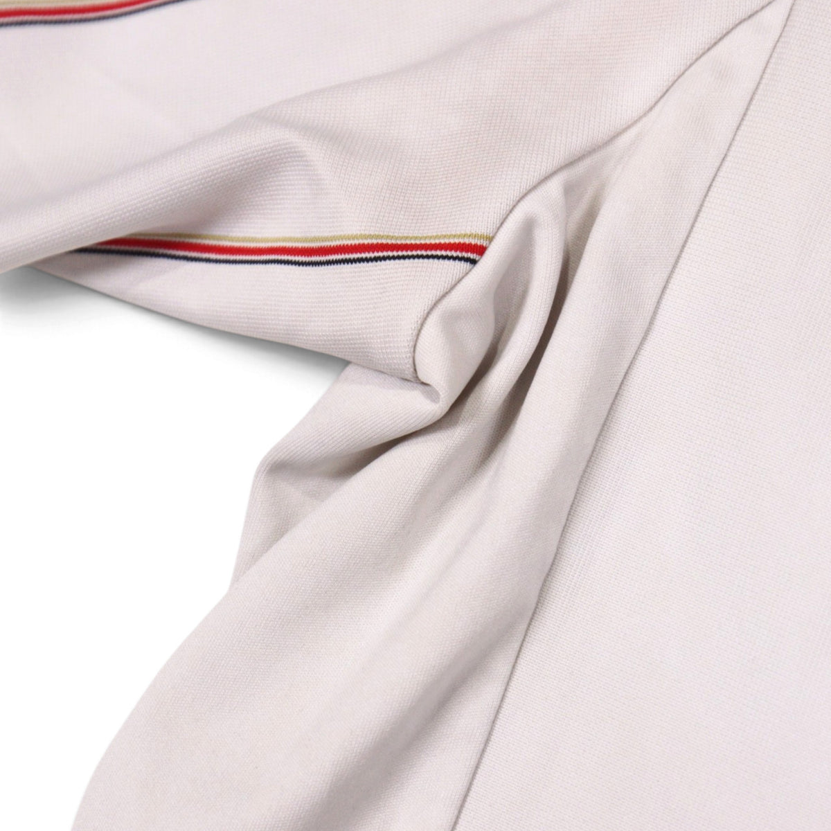 Close-up of the shirt fabric showing the collar trim and hem seam