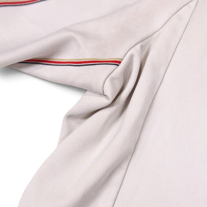 Close-up of the shirt fabric showing the collar trim and hem seam