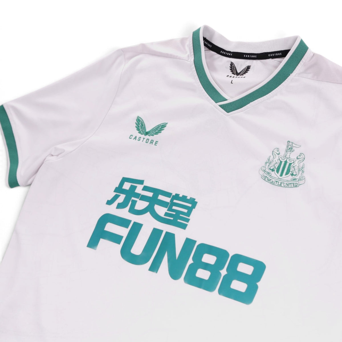 Newcastle United third shirt neck label showing size L and Castore branding