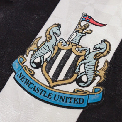 Close-up of Newcastle United crest on chest