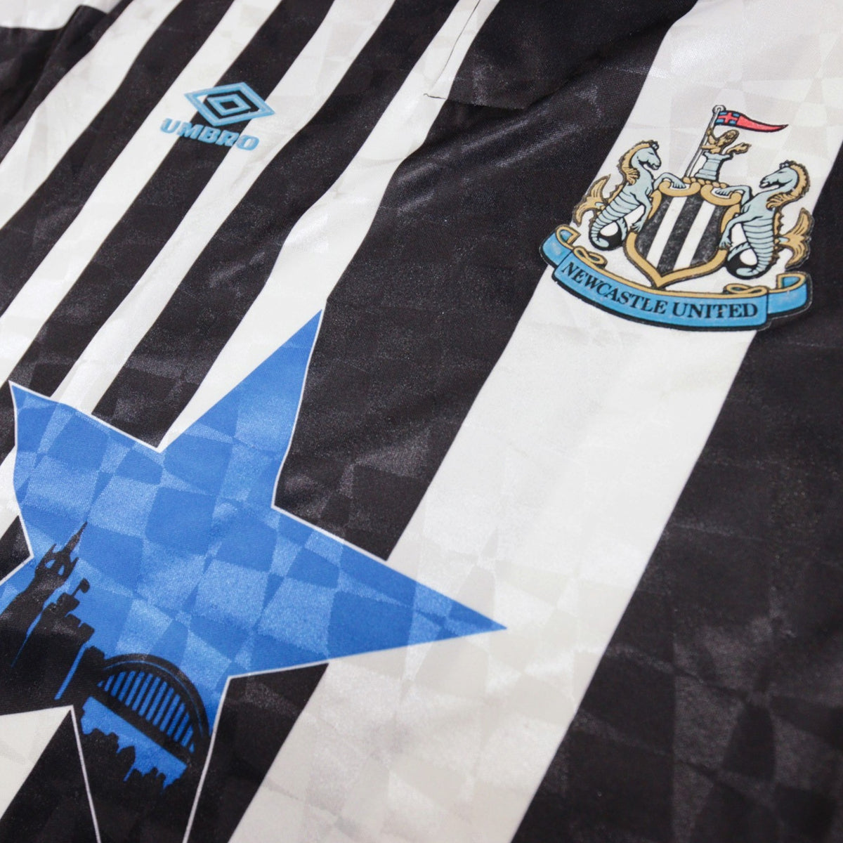 Close-up of chest showing Umbro logo, star design and crest together