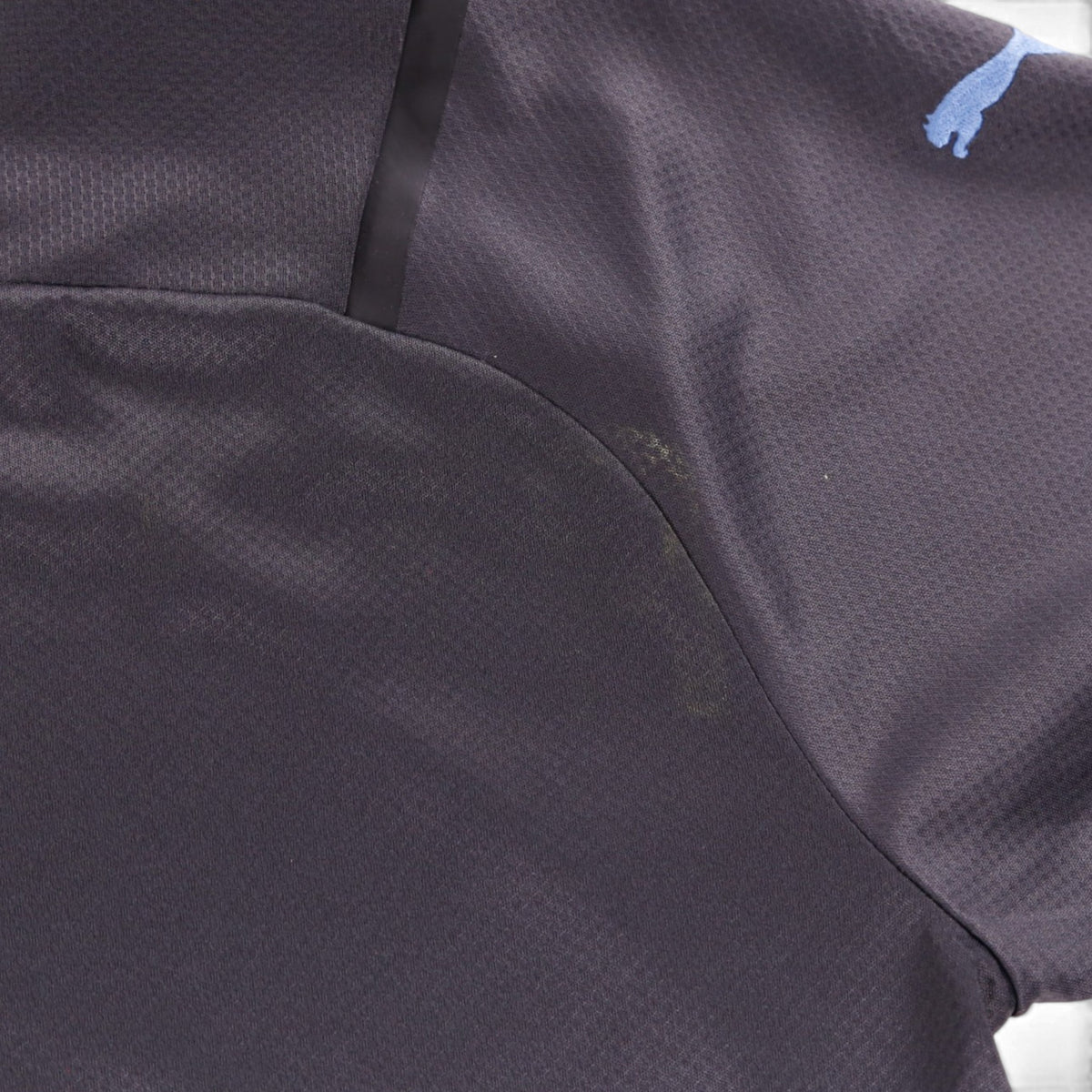 Close-up of the underarm seam area of the shirt showing a faint mark on the fabric.