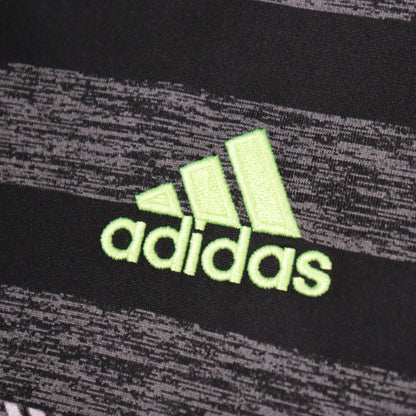 Close-up of the adidas logo on the shirt fabric