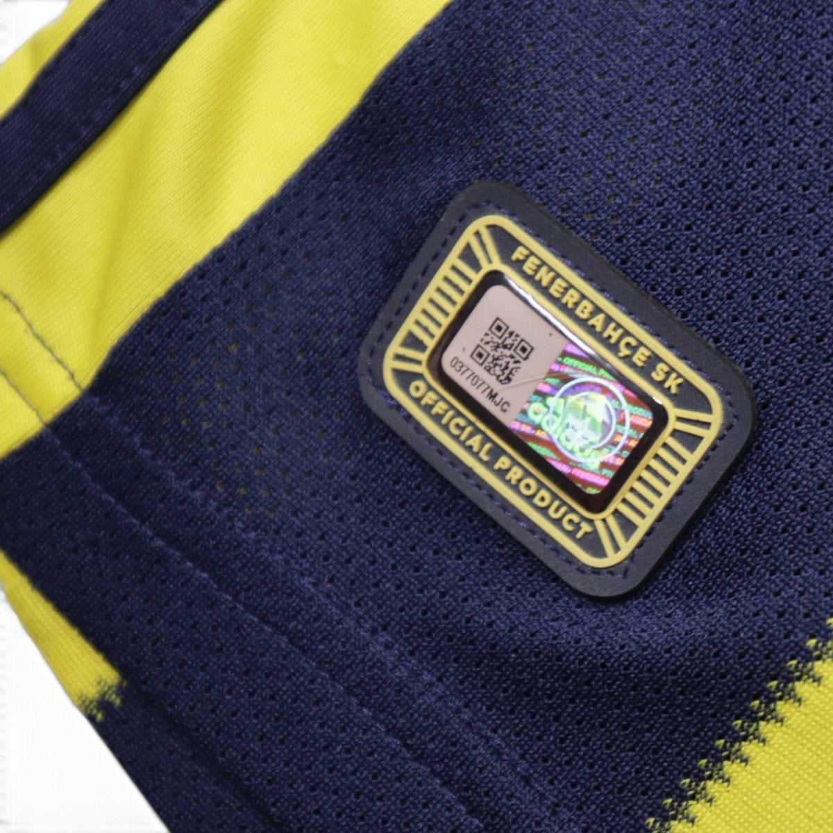 Close-up of official product hologram tag on the shirt hem