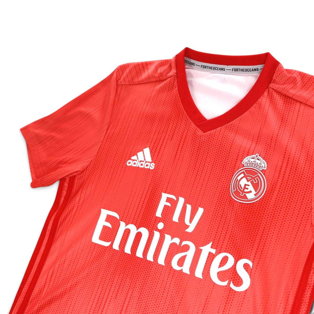 Close-up of the Real Madrid crest, adidas logo and collar on the third shirt