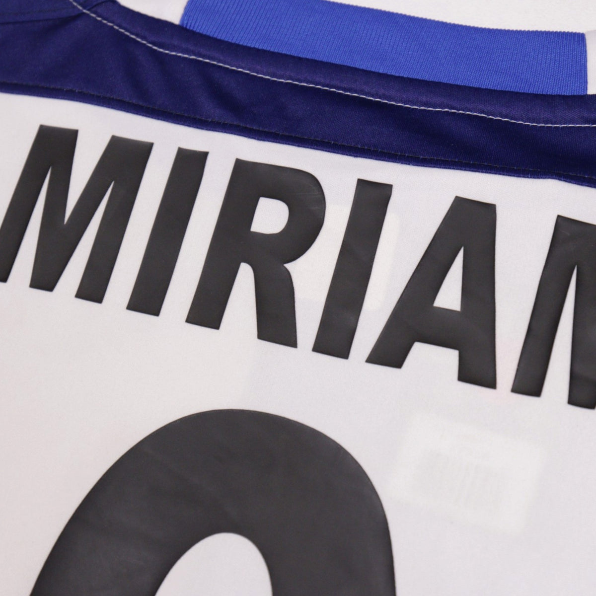 Close-up of collar and name/number print showing stitching and fabric detail