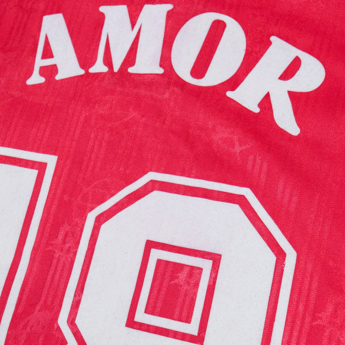 Close-up of Amor and number 18 print on the back of the shirt