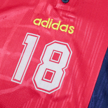 Close-up of adidas logo and number 18 on the chest