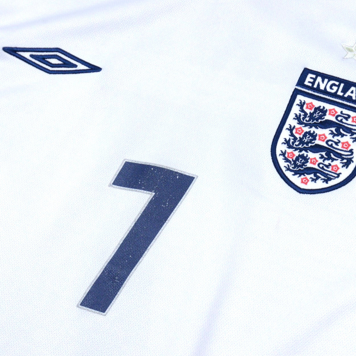 Close-up of the Umbro logo, number 7 and England crest on the chest