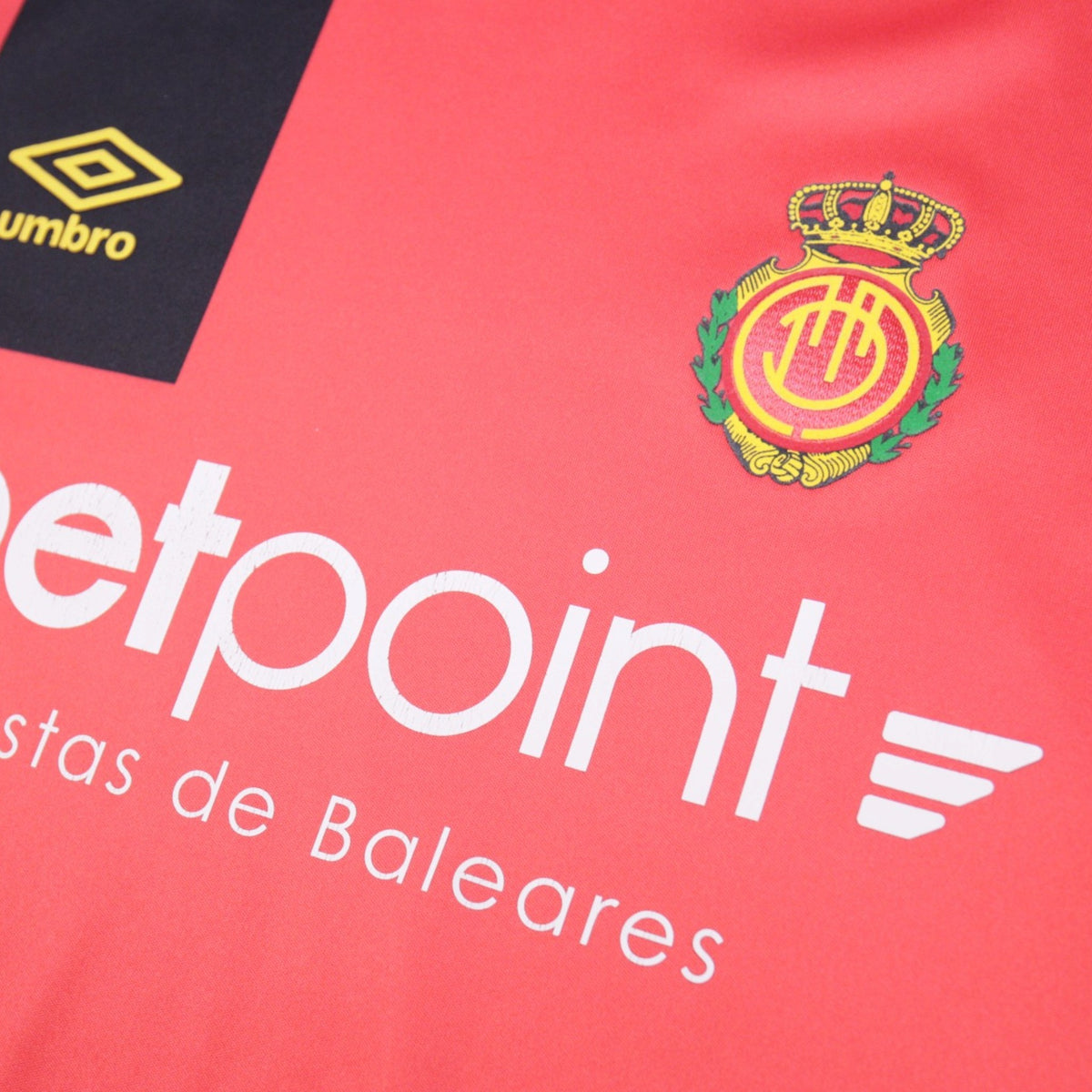 Close-up of Mallorca crest and Umbro logo on the home shirt