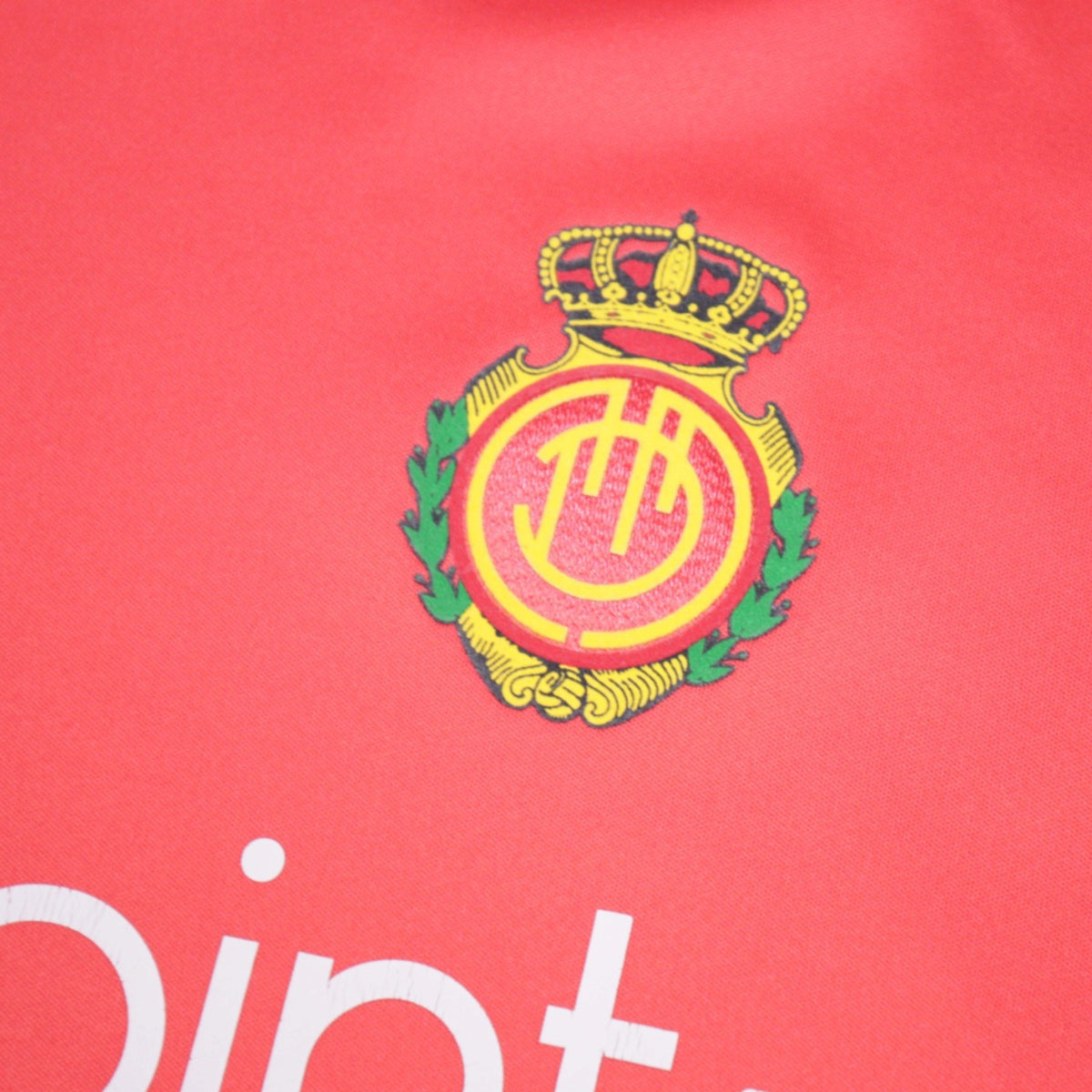 Close-up of the Mallorca crest printed on the front of the shirt